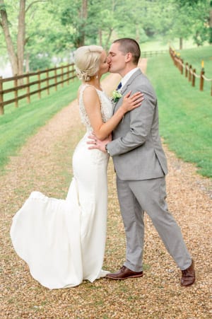 Bride & groom kiss Wedding portrait on a path at 'Four Winds at North Mountain' in Swoope VA