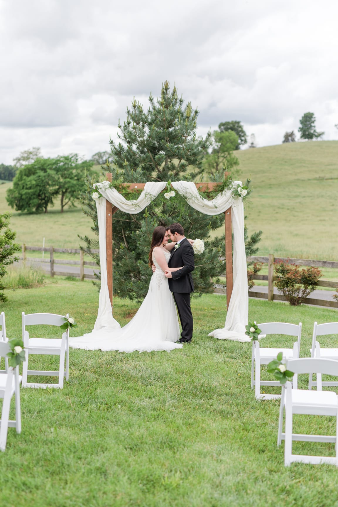 Bride & groom kiss Wedding portrait on a path at 'Four Winds at North Mountain' in Swoope VA
