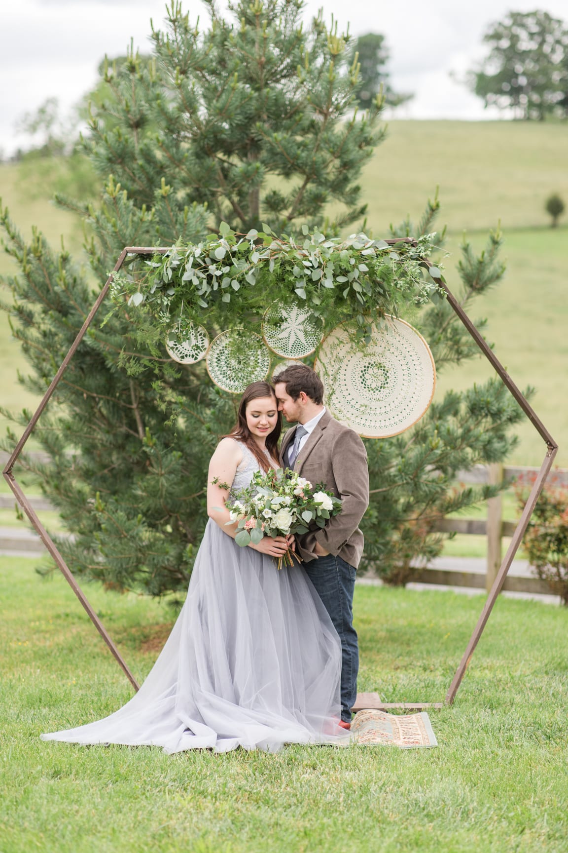 Bride & groom kiss Wedding portrait on a path at 'Four Winds at North Mountain' in Swoope VA
