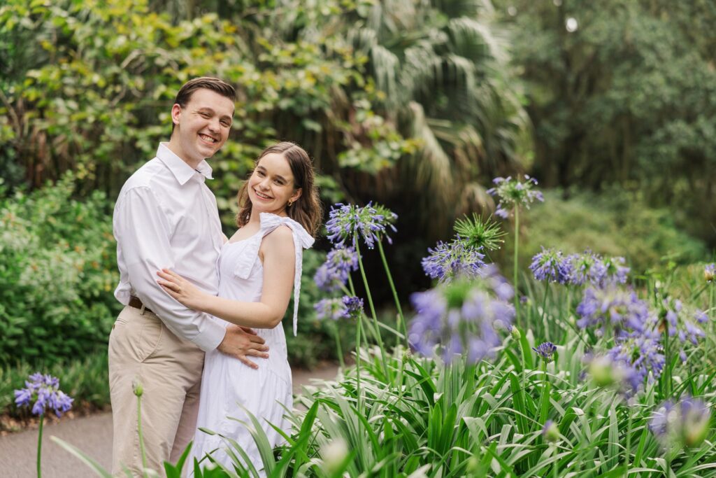 Couple on a garden path lined with purple blooms